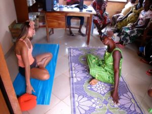 allyson anatra instructing neck stretch in maternity clinic Ghana West Africa